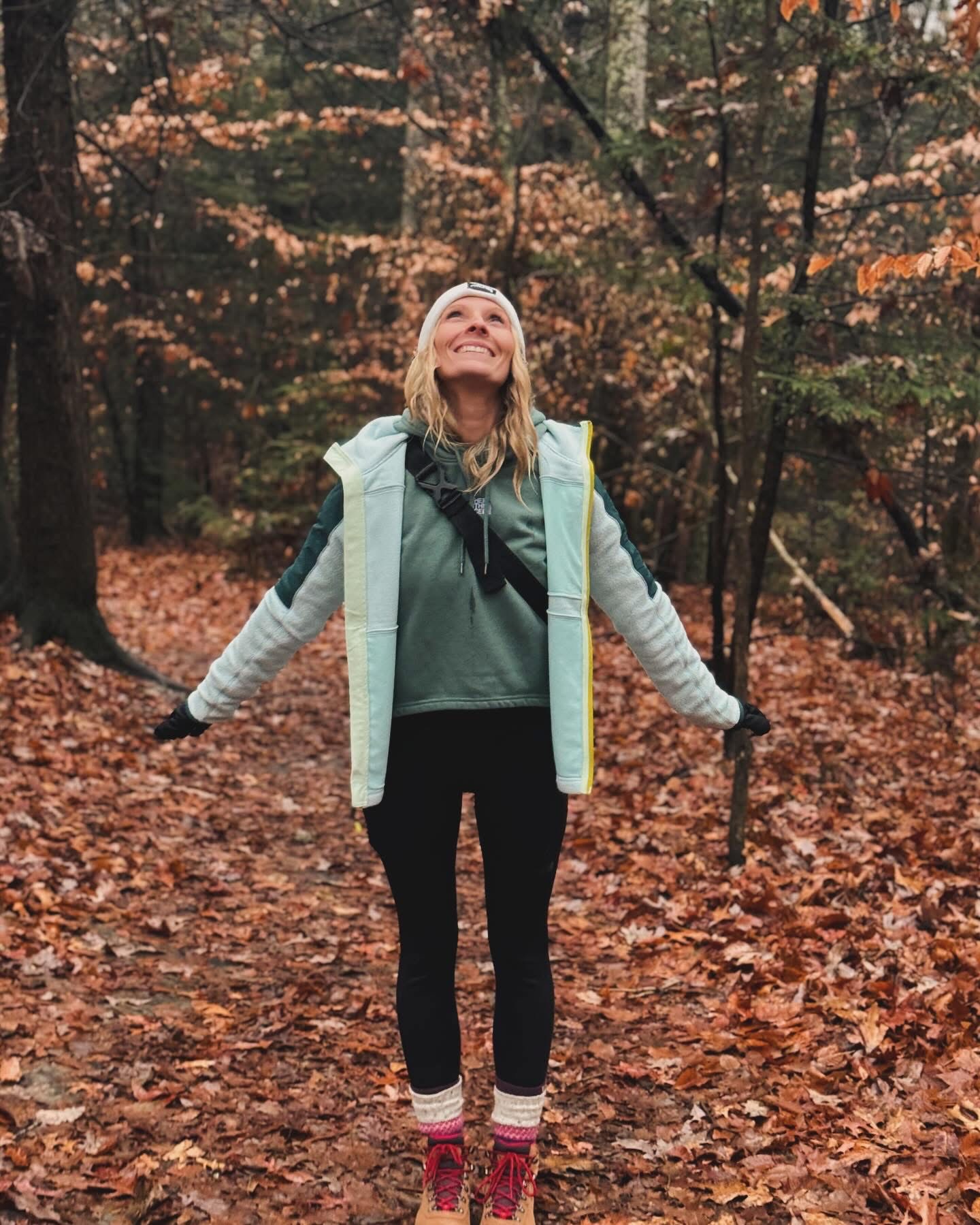 Nicole smiling in the fall woods